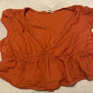 Orange short sleeve crop top with a V-neck
